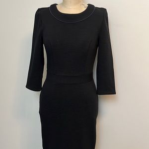 The perfect black dress!  Sophisticated and body conscious fitted to knee.